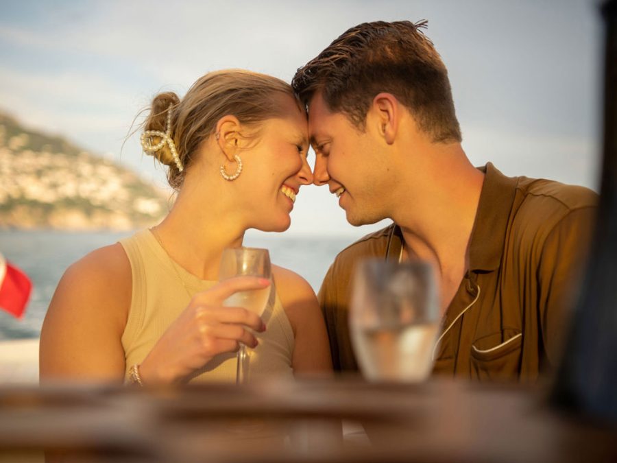 private-boat-tour-amalfi-coast-couple-embrace-praiano-background